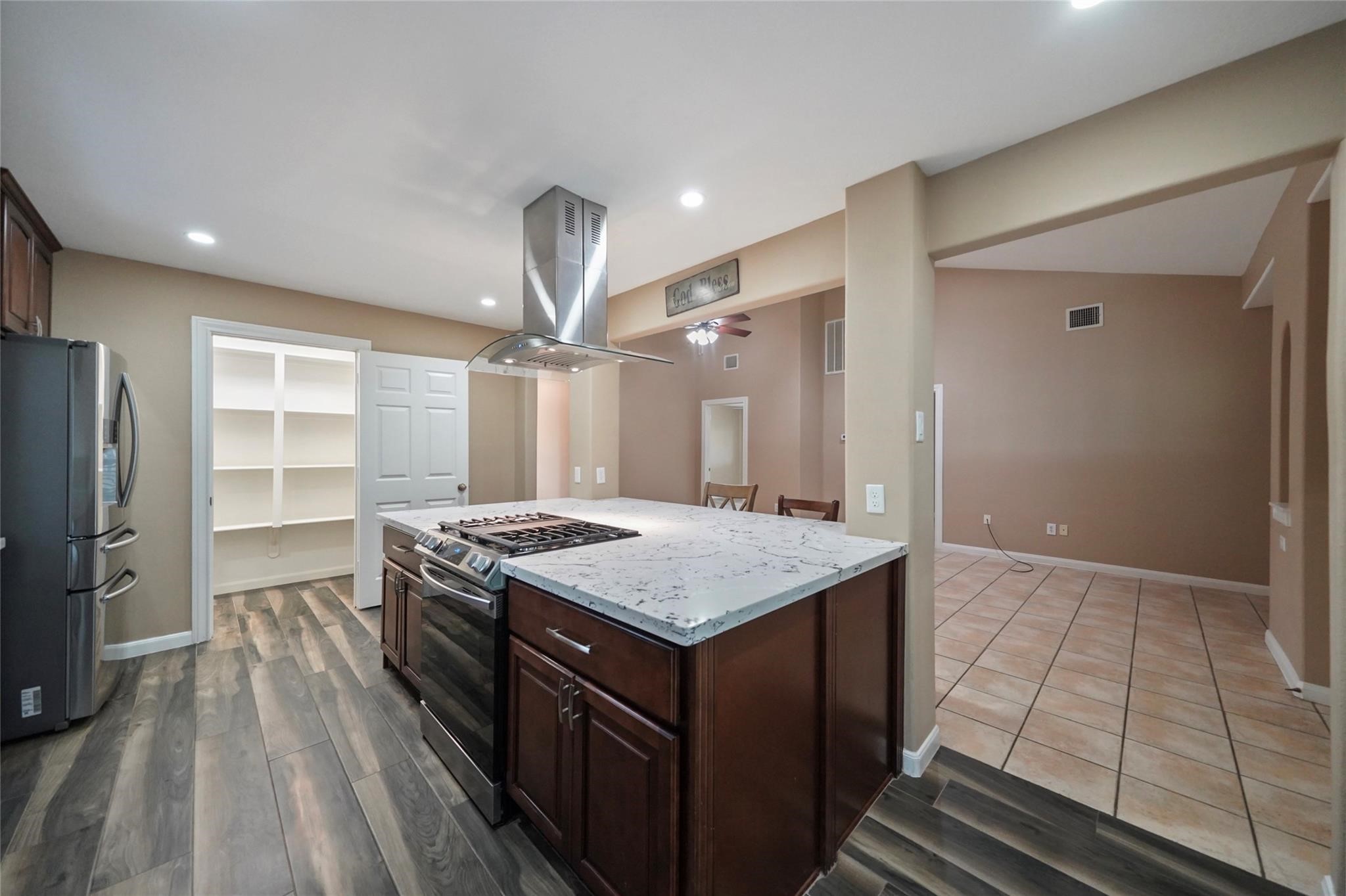 30720 Waller Spring Creek Road Waller, TX 77484 - Photo 6 of 22 Island kitchen highlited with gas range and convenient view into the walk-in pantry.