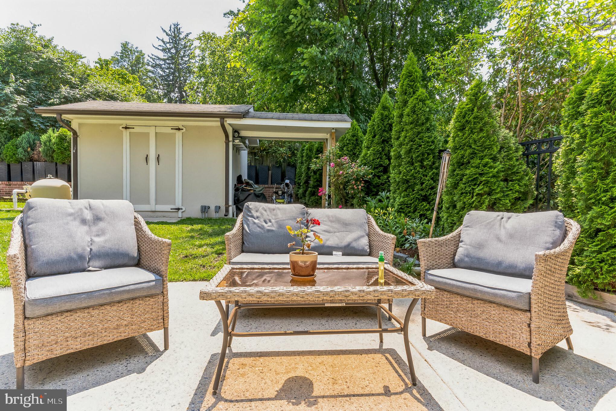 9329 Harvey Road Silver Spring, MD 20910 - Photo 34 of 40 a view of a patio with couches table and chairs and potted plants
