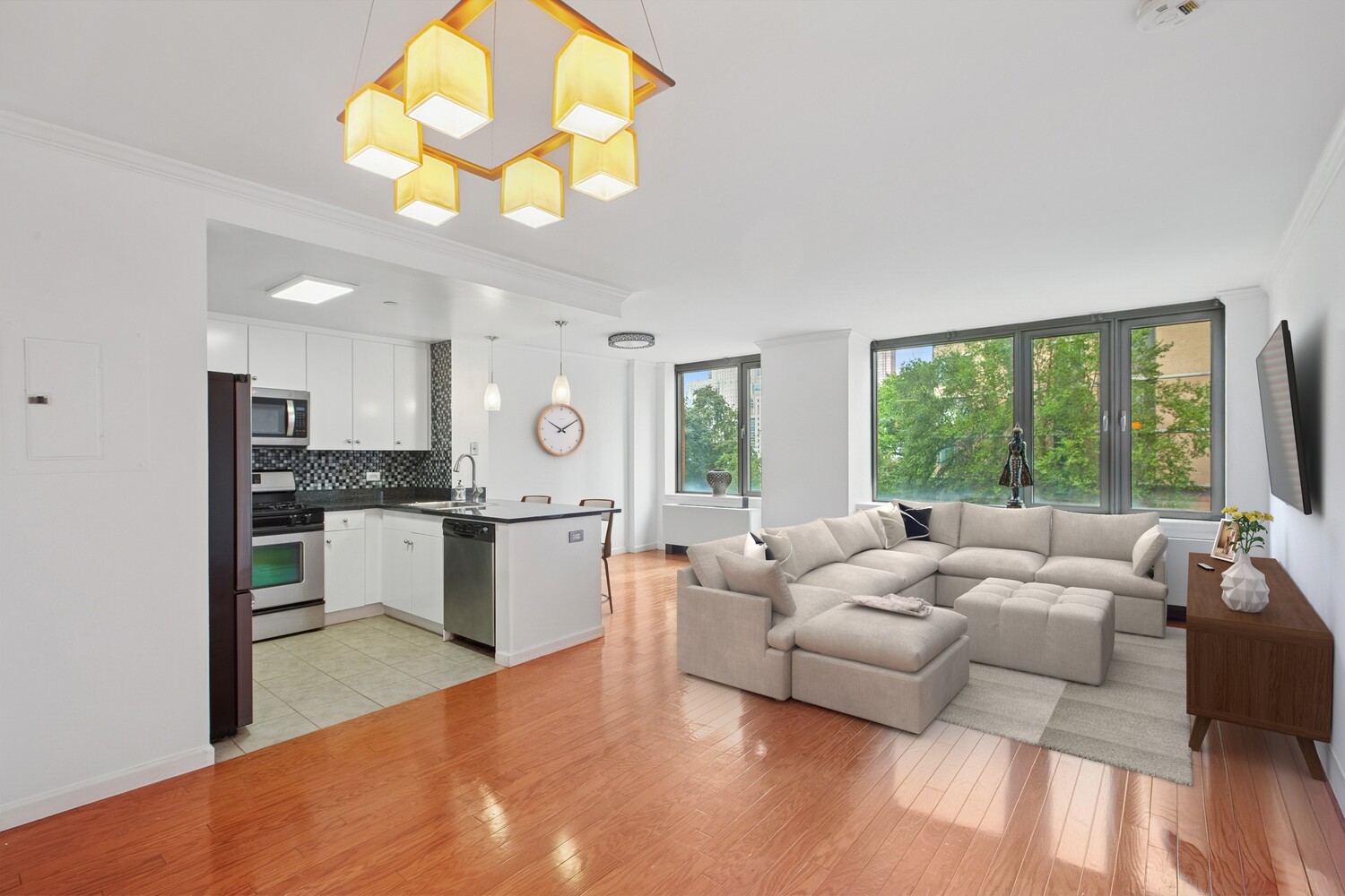 455 Main Street, Unit 4K Manhattan, NY 10044 - Photo 1 of 16 a living room with kitchen island furniture and a large window
