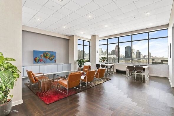 455 Main Street, Unit 4K Manhattan, NY 10044 - Photo 11 of 16 a living room with furniture and a large window