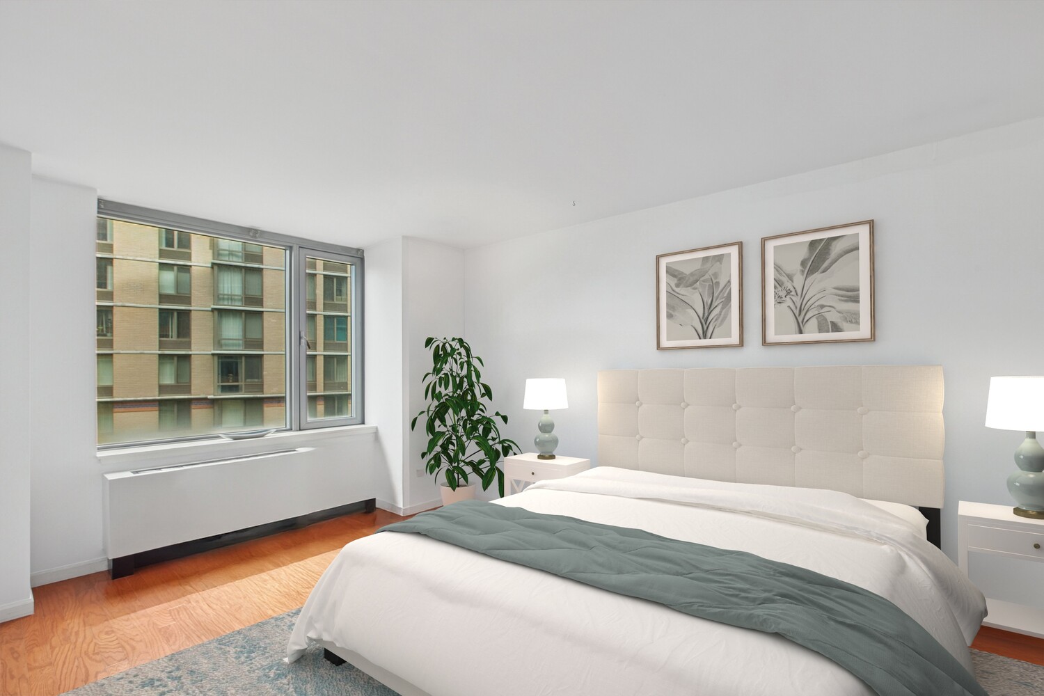 455 Main Street, Unit 4K Manhattan, NY 10044 - Photo 5 of 16 a bedroom with a bed and a window