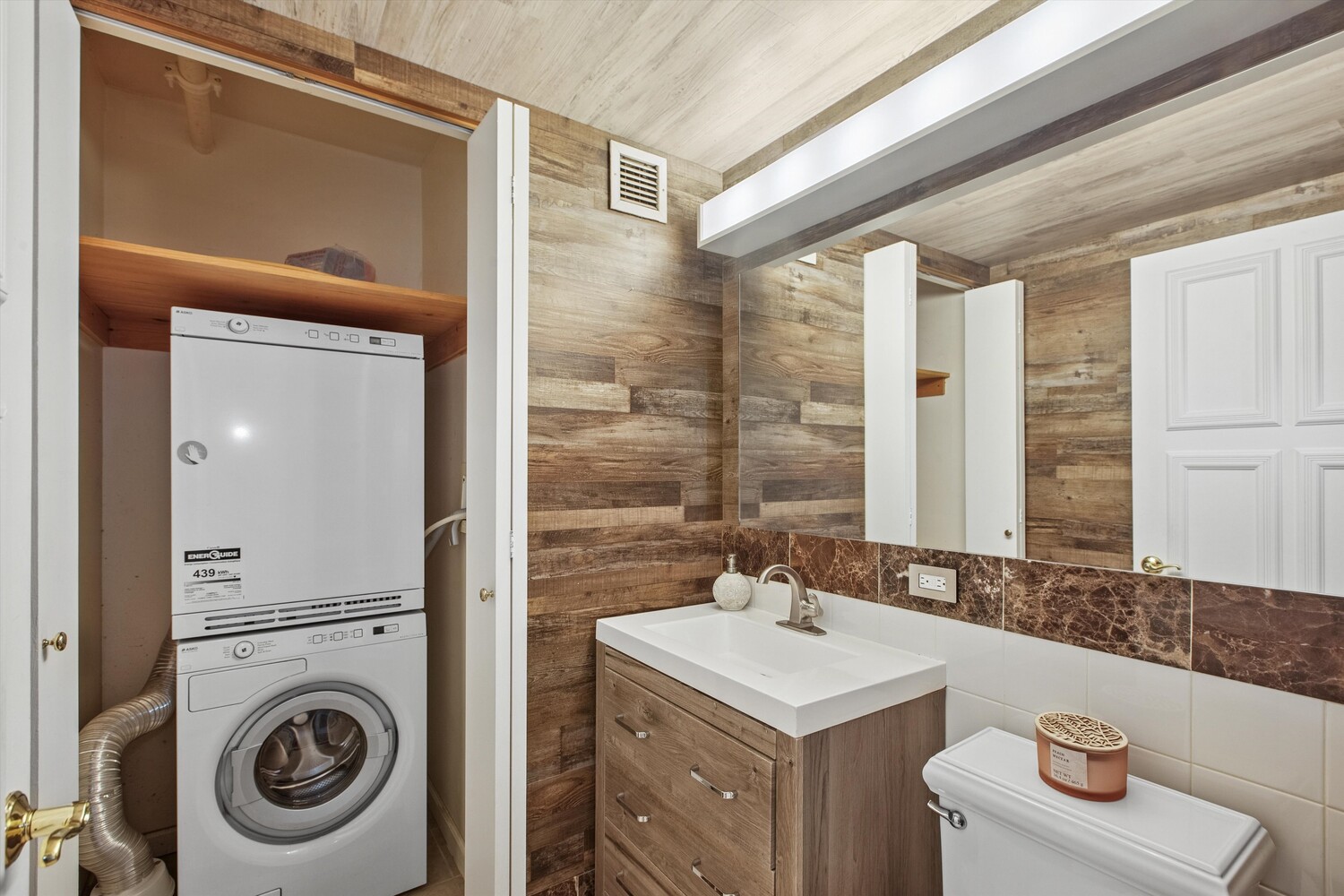 455 Main Street, Unit 4K Manhattan, NY 10044 - Photo 8 of 16 a bathroom with a sink a washer and dryer