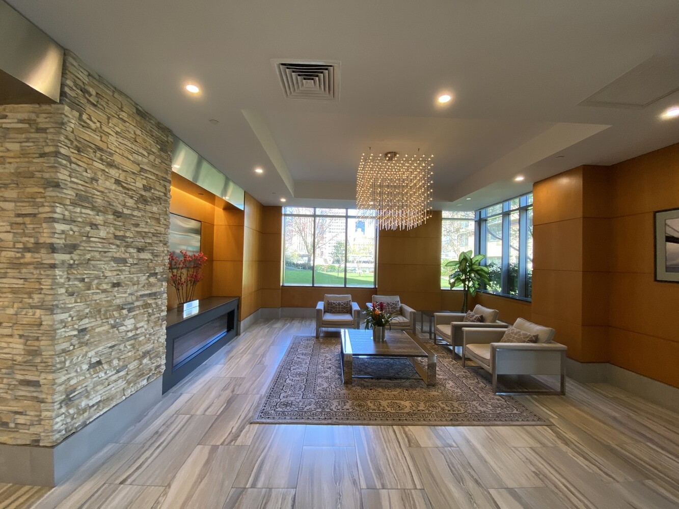 455 Main Street, Unit 4K Manhattan, NY 10044 - Photo 10 of 16 a living room with fireplace furniture wooden floor and a rug