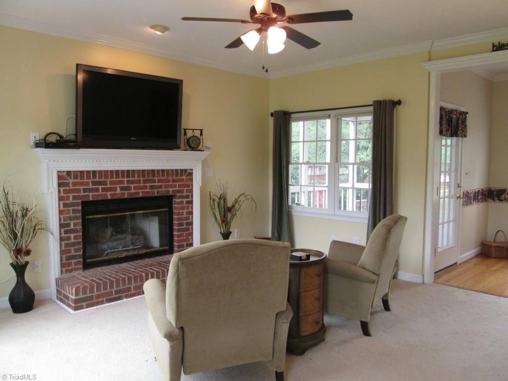 2800 Norwell Court Oak Ridge, NC 27310 - Photo 2 of 22 Living Room fireplace with gas logs over looking cozy screened porch.