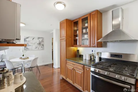 a kitchen with a dining table chairs and refrigerator
