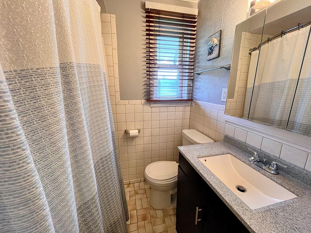 1192 Washington Street Indiana, PA 15701 - Photo 11 of 19 a bathroom with a granite countertop sink toilet and mirror