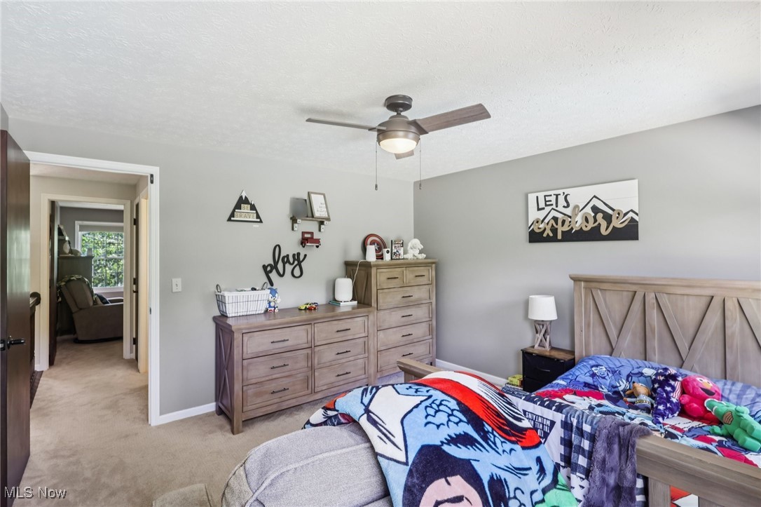 230 South Medina Line Road Akron, OH 44321 - Photo 24 of 50 Bedroom with light carpet, a textured ceiling, and ceiling fan