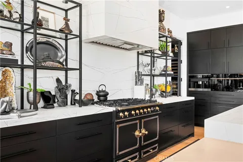 a kitchen with stainless steel appliances granite countertop a stove and a sink