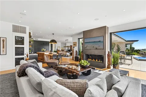 a living room with fireplace furniture and a large window