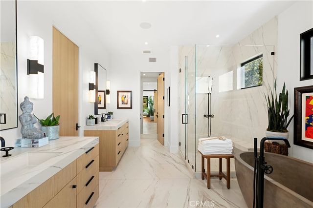 a spacious bathroom with a granite countertop sink a mirror a bathtub and a shower