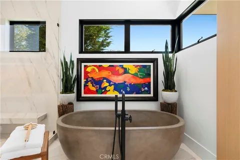 a picture of a living room with a couch and a painting on the wall