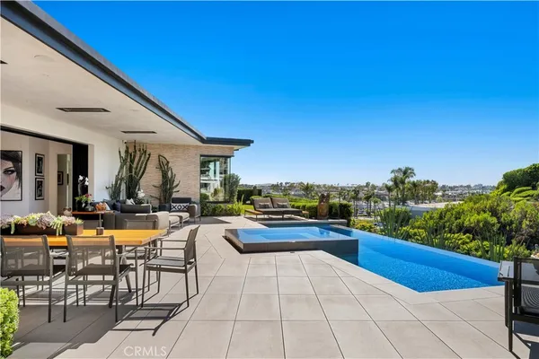 an aerial view of residential houses with outdoor space and seating