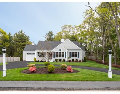 a front view of a house with a garden and plants