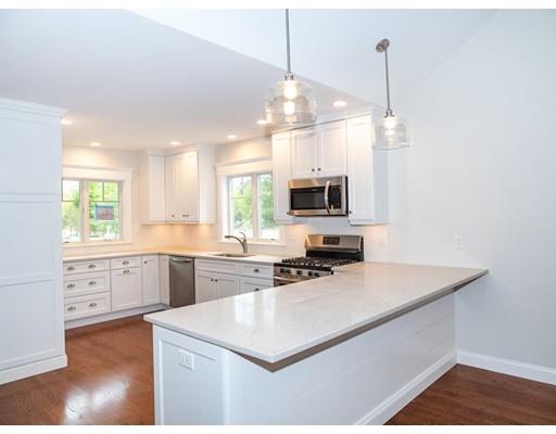218 Bumps River Road Barnstable, MA 02655 - Photo 3 of 11 a kitchen with microwave a stove and white cabinets