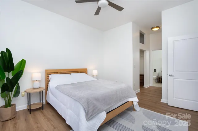 a bedroom with a bed and a potted plant