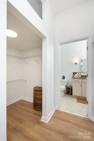 a bedroom with a bed and a view of kitchen