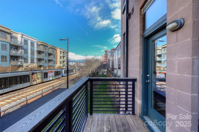 a view of balcony with floor to ceiling windows with wooden floor