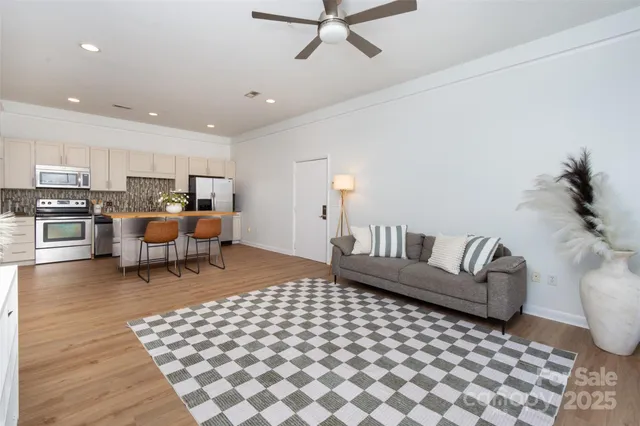 a living room with furniture and a wooden floor