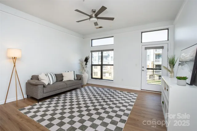 a living room with a couch and a table with wooden floor
