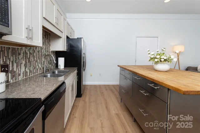 a kitchen with a granite countertop counter space a sink and appliances