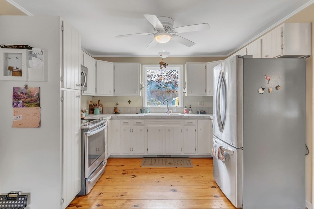 149 Boston Road Palmer, MA 01069 - Photo 8 of 35 a kitchen with stainless steel appliances a refrigerator sink and cabinets