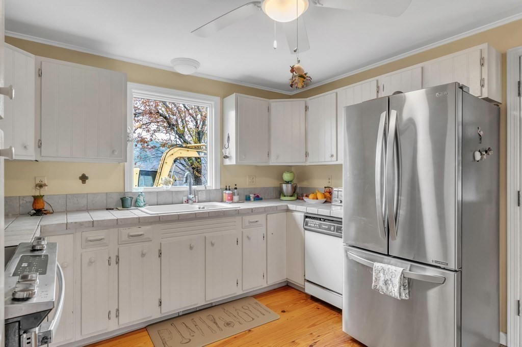 149 Boston Road Palmer, MA 01069 - Photo 9 of 35 a kitchen with stainless steel appliances a refrigerator sink and cabinets