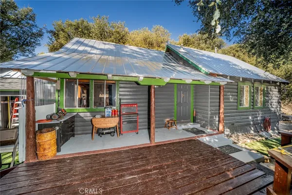 a view of a patio with table and chairs under an umbrella with wooden floor