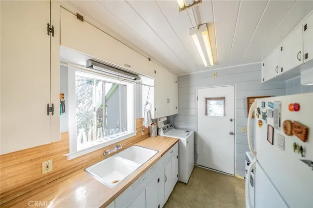 a spacious bathroom with a tub sink and mirror