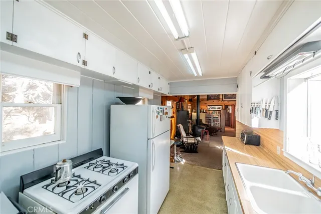 a view of a kitchen with workspace and a window