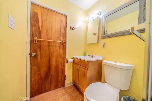a bathroom with a sink a toilet a mirror and shower curtain