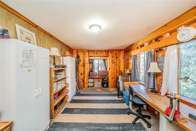 a living room with furniture a rug and a large window