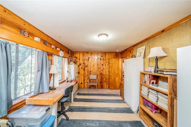 a very nice looking room with many windows and furniture