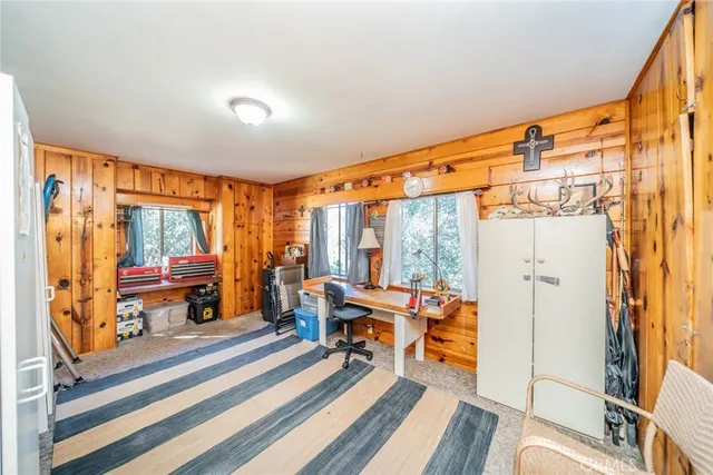 a living room with furniture a large window and wooden floor