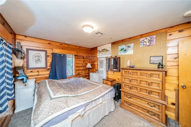 a bedroom with furniture and a dresser