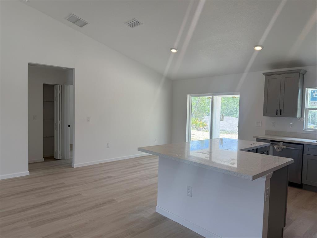 12847 Southwest 84th Terrace Road Ocala, FL 34473 - Photo 2 of 16 an empty room with wooden floor and a window