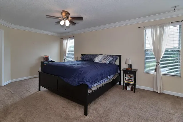 a bathroom with a granite countertop bathtub a sink and a large mirror