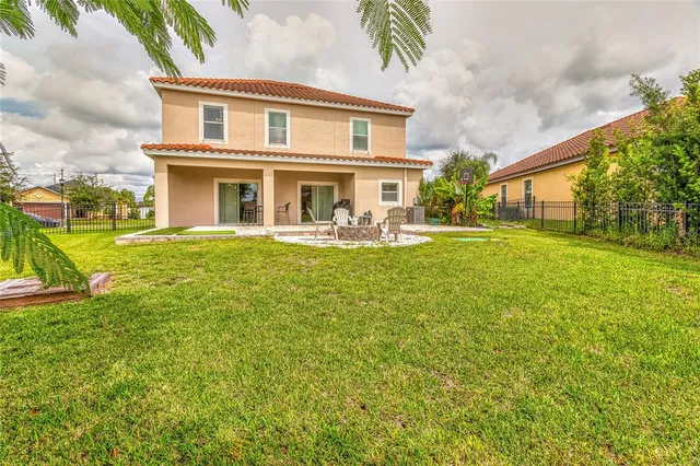 an aerial view of residential houses with outdoor space and swimming pool
