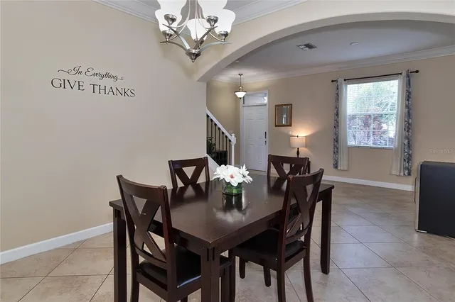 a view of a dining room with furniture and chandelier