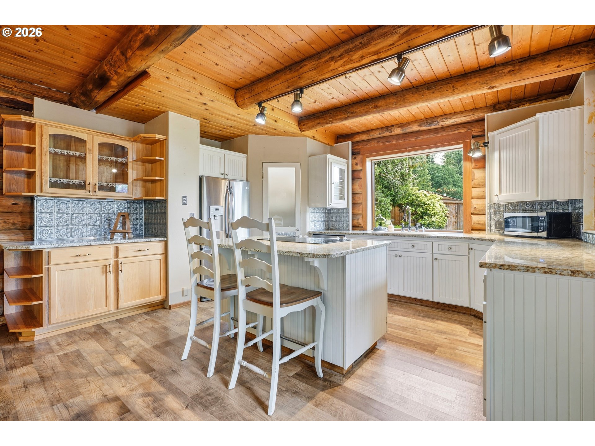 29870 South Dhooghe Road Colton, OR 97017 - Photo 3 of 48 a kitchen with stainless steel appliances kitchen island granite countertop a table chairs in it and wooden floors