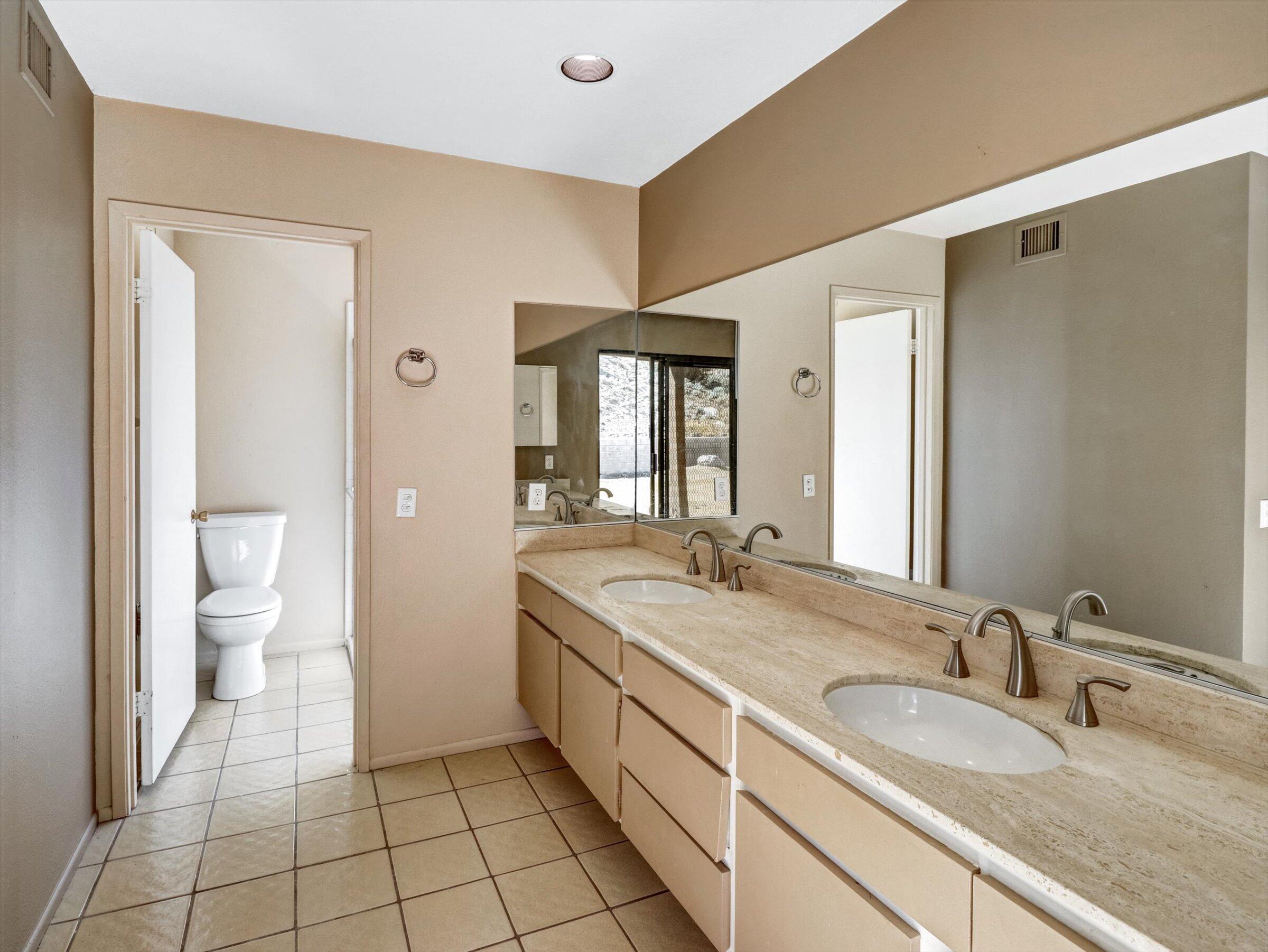 67805 Foothill Road Cathedral City, CA 92234 - Photo 13 of 22 a spacious bathroom with a granite countertop sink and a mirror