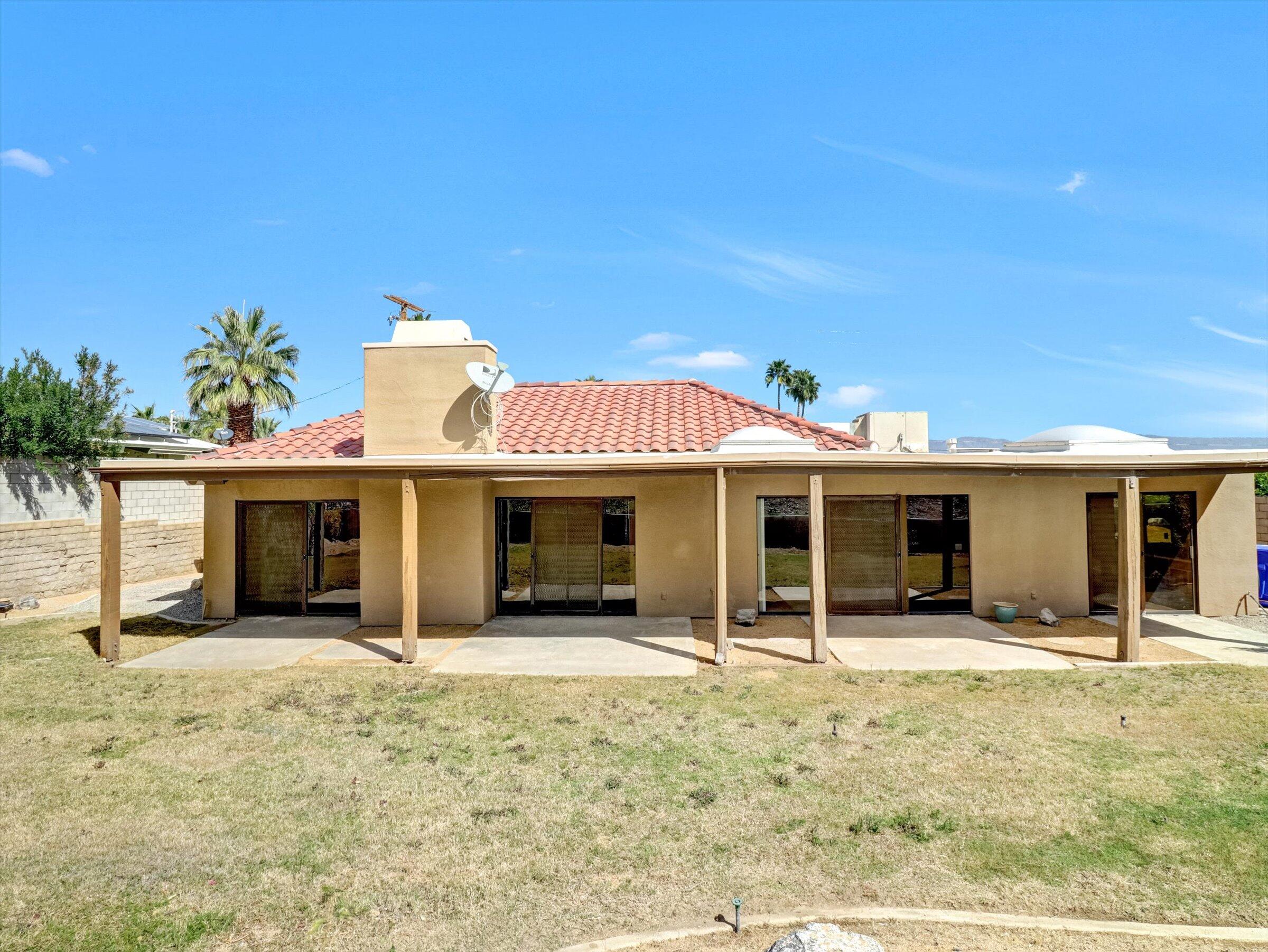 67805 Foothill Road Cathedral City, CA 92234 - Photo 18 of 22 a view of a house with floor to ceiling windows and a basket ball poll