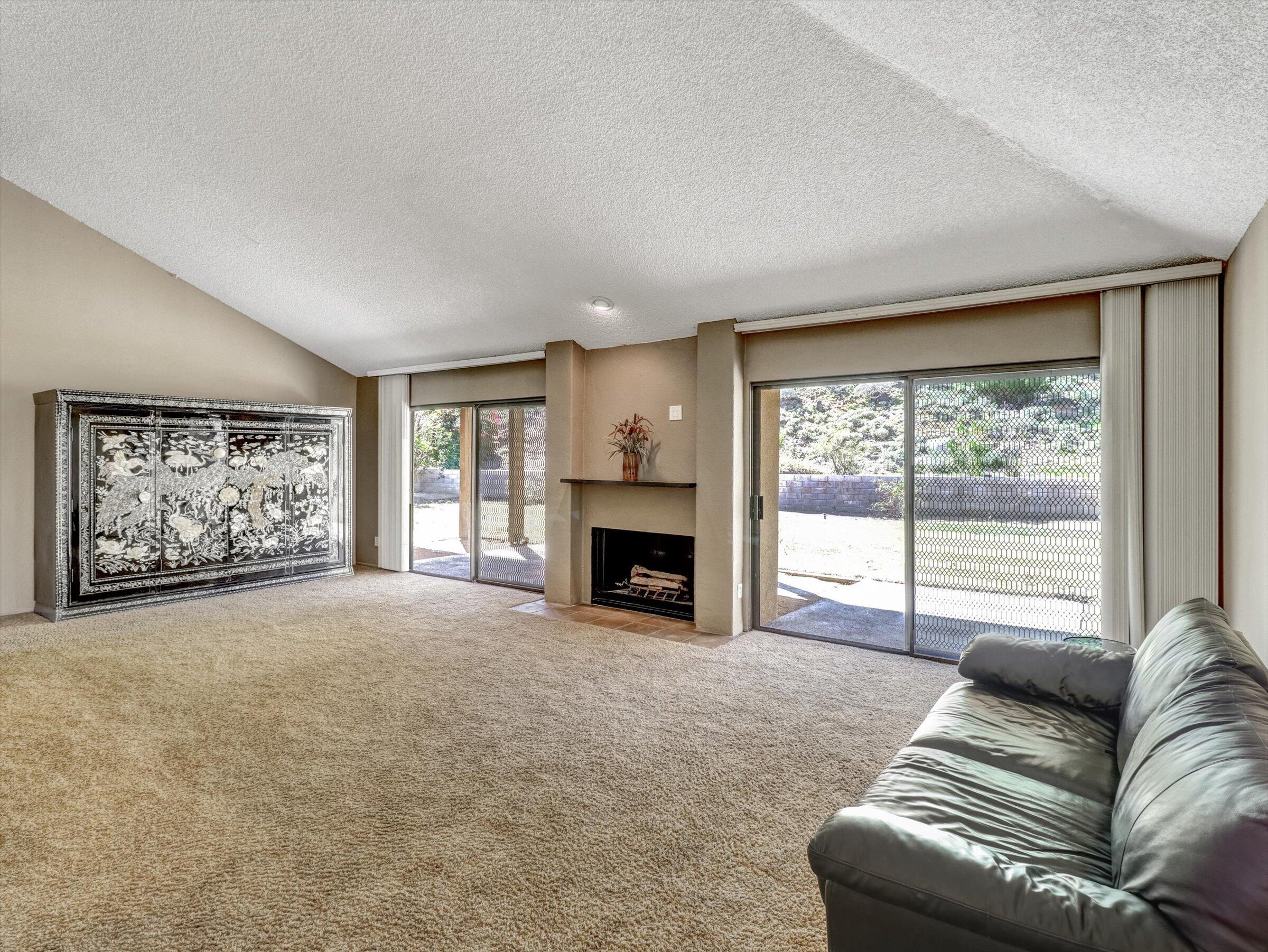 67805 Foothill Road Cathedral City, CA 92234 - Photo 5 of 22 a living room with furniture and a fireplace