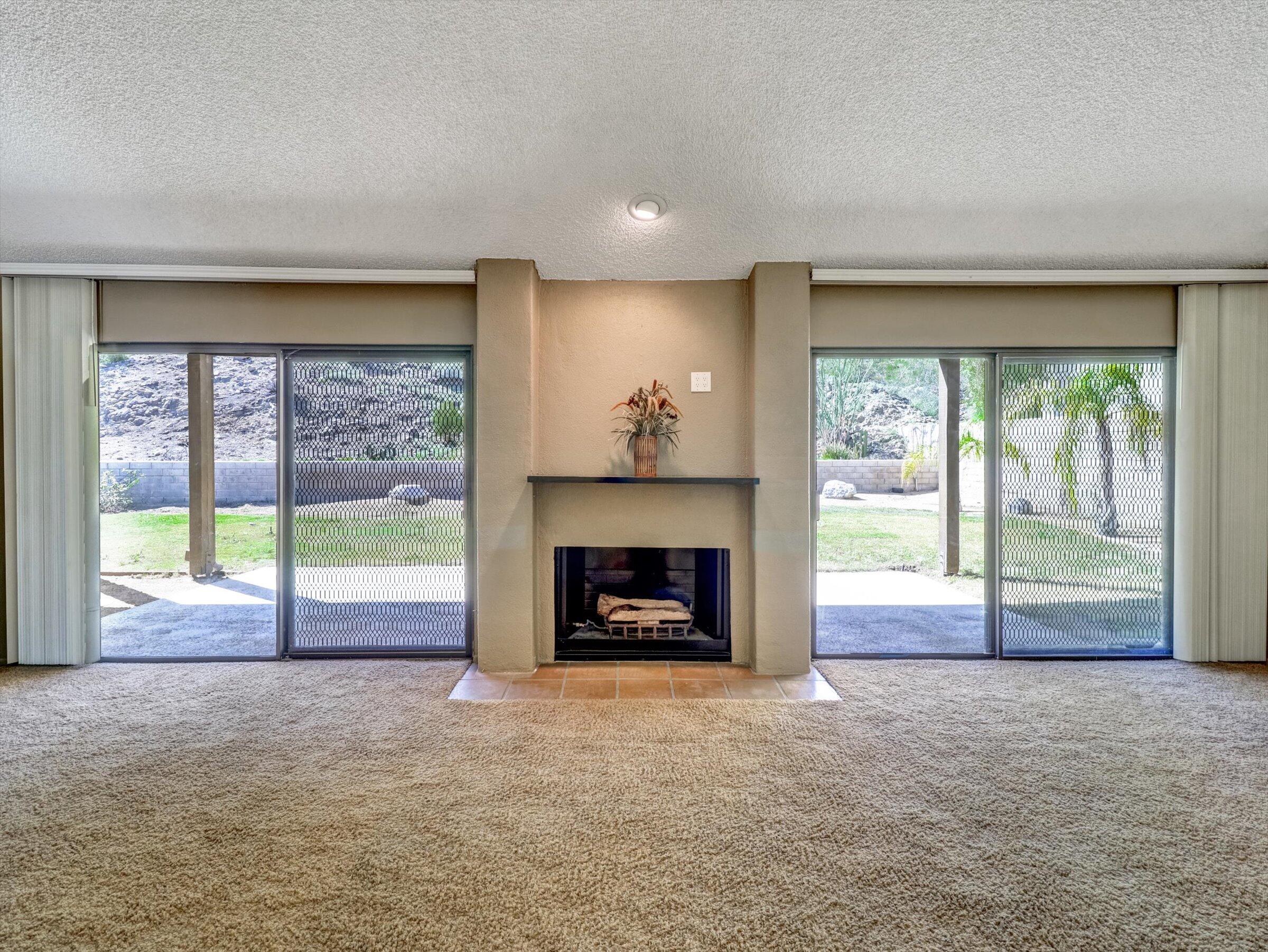 67805 Foothill Road Cathedral City, CA 92234 - Photo 10 of 22 a view of an empty room with a fireplace and a window