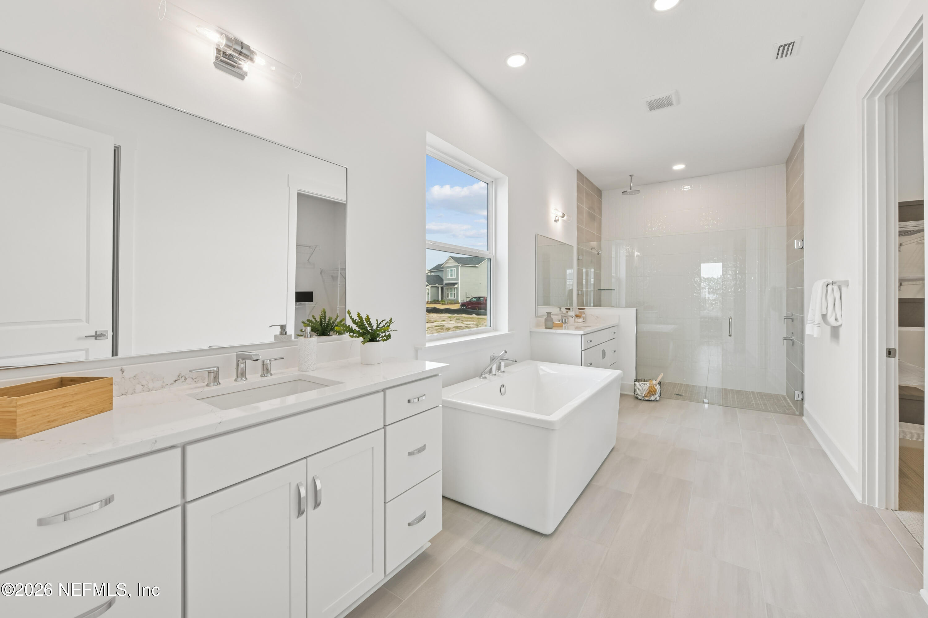 195 Bismarck Palm Road St. Augustine, FL 32092 - Photo 12 of 25 a spacious bathroom with a double vanity sink mirror and bathtub