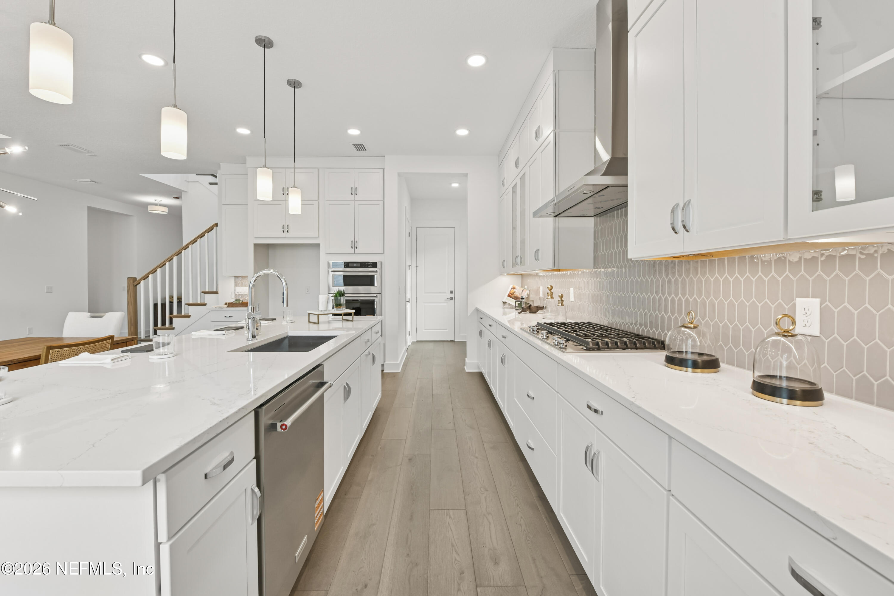 195 Bismarck Palm Road St. Augustine, FL 32092 - Photo 8 of 25 a large kitchen with stainless steel appliances kitchen island a large counter top a sink a stove and a window