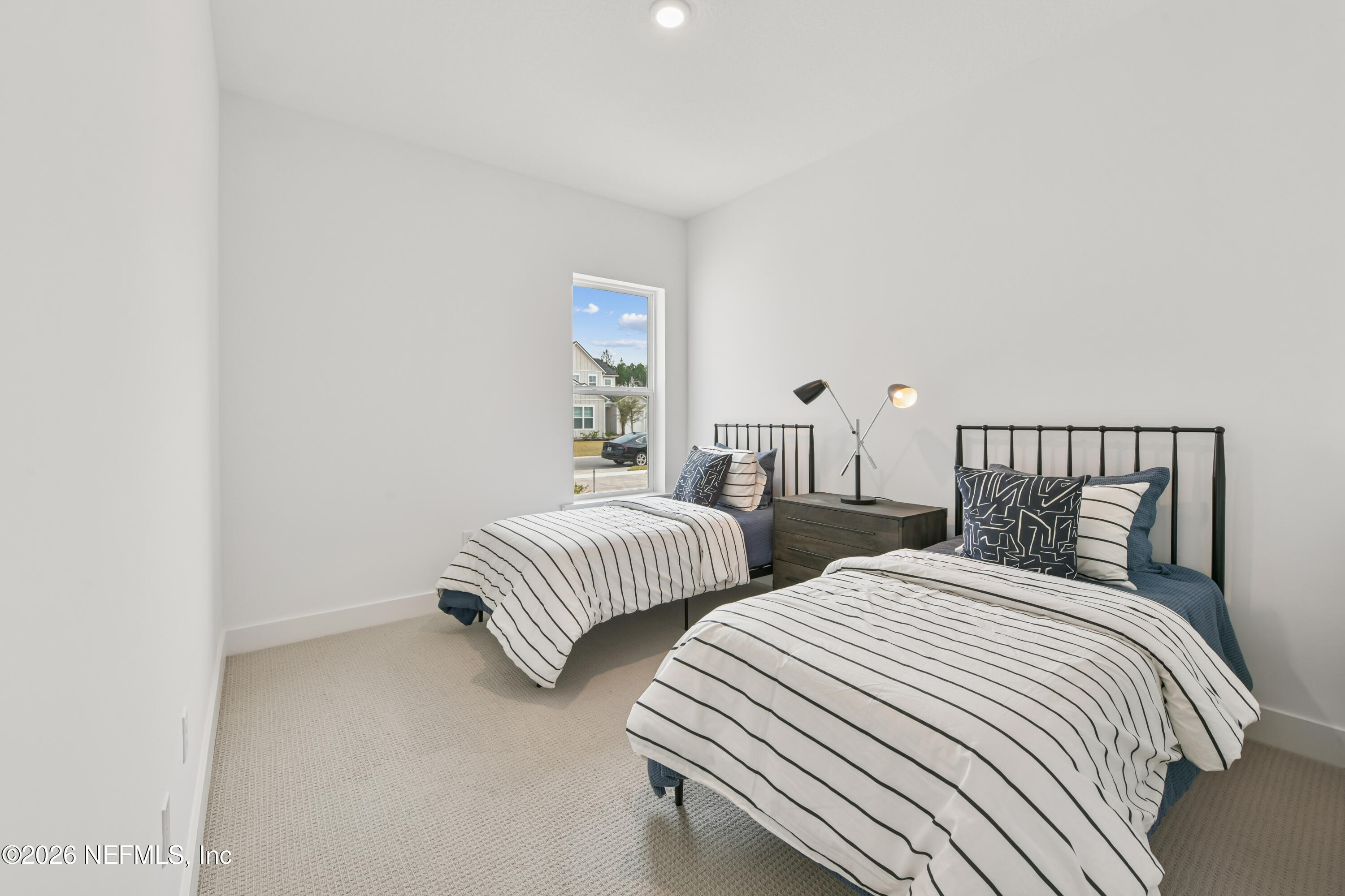 195 Bismarck Palm Road St. Augustine, FL 32092 - Photo 10 of 25 a bedroom with two beds and a window