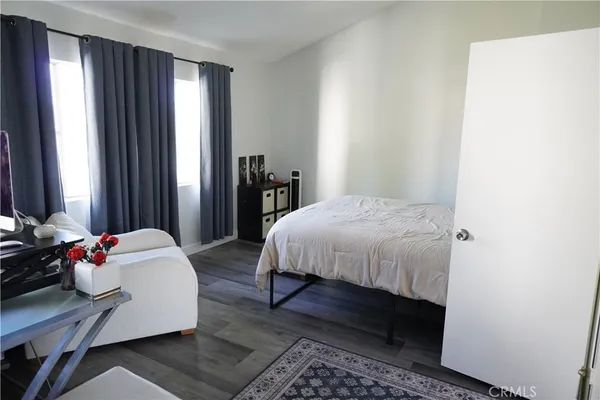 a bedroom with a bed and a mirror