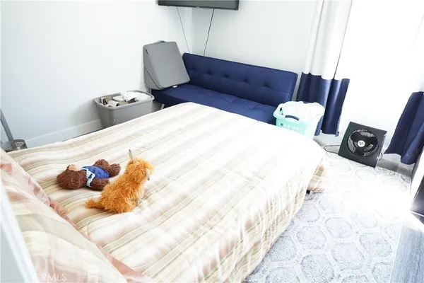 a bed sitting in a bedroom next to a window