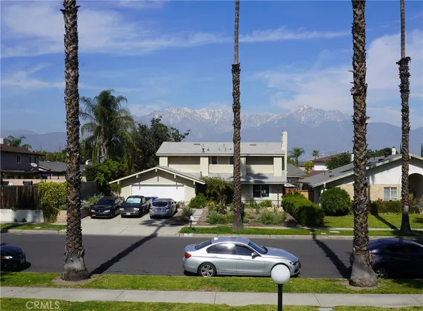 a view of a parking space with cars parked on the roadside