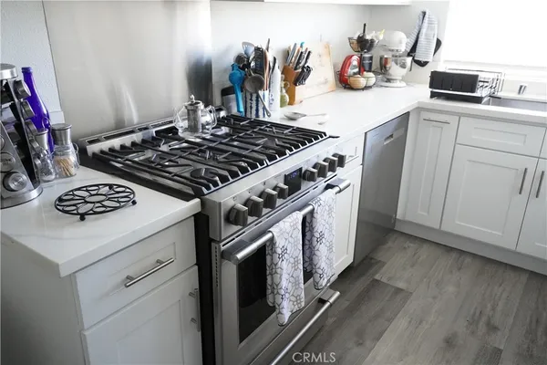 a white stove top oven sitting inside of a kitchen